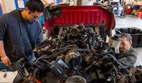 Picture of student repairing an auto engine