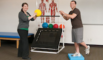 Physical Therapist training a patient